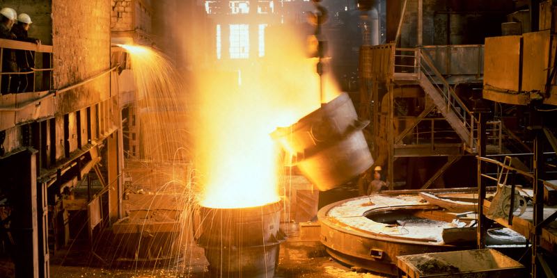 Molten metal and sparks inside a furnace